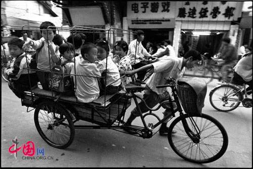 Cycle rickshaw driver taking children to school, Chengdu, 1995
