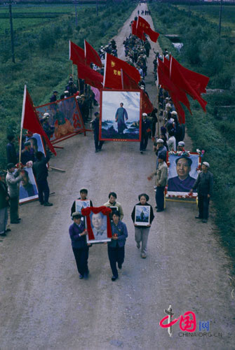 Educated young people marching with their copied portraits of Mao Zedong to express resolution to follow Mao's spirit 