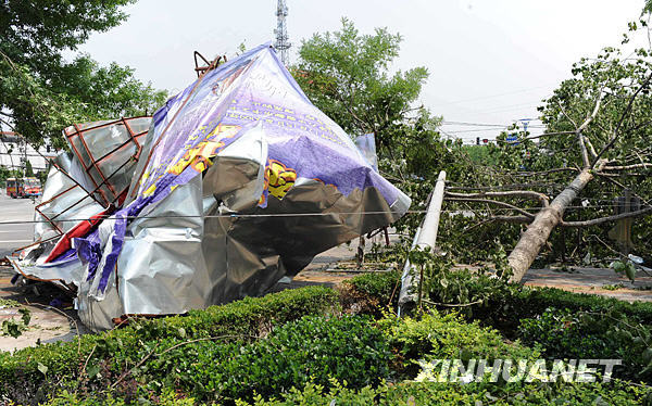 A billboard is seen twisted on June 4, 2009 by a strong storm Wednesday night in Shangqiu city of central China's Henan Province. [Xinhua]