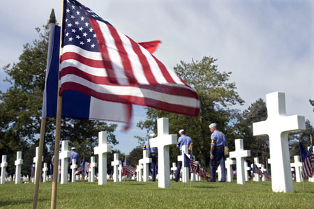 U.S. and French flags adorn grave markers at the U.S. war cemetery at Colleville-sur-mer in Normandy June 5, 2009. U.S. President Barrack Obama and other leaders will attend ceremonies here June 6, 2009 marking the 65th anniversary of the allied landings on D-Day.