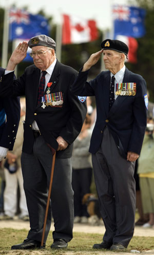 Canadian veterans of the Normandy D-Day invasion Garth Webb (L) of Burlington, Ont. and Harold Tilley of Ottawa salute during a ceremony on 