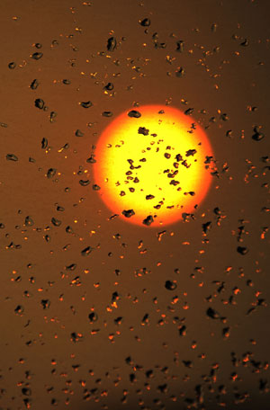 The sun is seen through the rainwater on window in Jiaxing, east China's Zhejiang Province, June 5, 2009. A strong convective weather hit Jiaxing on Friday afternoon.