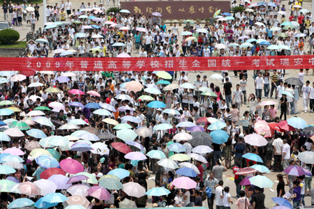 Chinese students and their family members walk home after they finished the first day tests of the National College Entrance Examination, which will last until Tuesday for three days across China, in Rui'an city in east China's Zhejiang province, June 7, 2009. Some 10.2 million Chinese school students are to compete this year in the world's largest annual examination for a quota of 6.29 million to learn in universities and colleges. (Xinhua/Zhuang Yingchang)