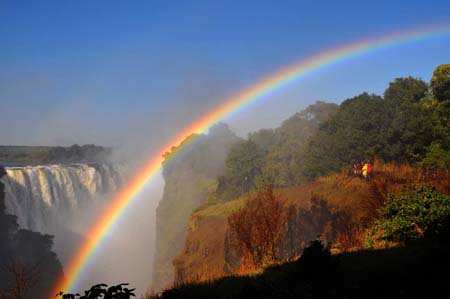 A rainbow appears at the Victoria Falls in the resort town of Victoria Falls in Zimbabwe, June 5, 2009. African largest economic bloc Common Market for Eastern and Southern Africa (COMESA) will hold its annual summit in the Zimbabwean resort town of Victoria Falls on June 7 to 8. [Xu Suhui/Xinhua] 