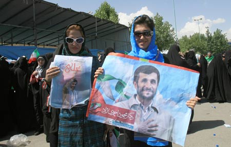 Two women show images of Iranian President Mahmoud Ahmadinejad during a presidental election campaign in Teheran, capital of Iran, June 8, 2009. Tens of thousdands of Mahmoud Ahmadinejad's supporters held a rally here on Monday, supporting the incumbent hardliner Mahmoud Ahmadinejad to grasp the second four-year term in the presidential elections on June 12. [Liang Youchang/Xinhua]