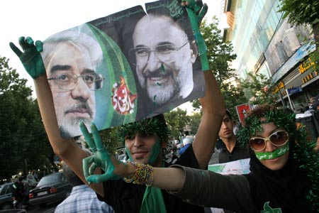 Supporters of Iranian presidential hopeful Mir Hossein Mousavi, former Prime Minister, hold posters of Mousavi during a presidential election campaign in Teheran, capital of Iran, June 8, 2009. Thousands of backers of Mousavi formed a human chain here on Monday to support him in the presidential elections on June 12. [Ahmad Halabisaz/Xinhua]