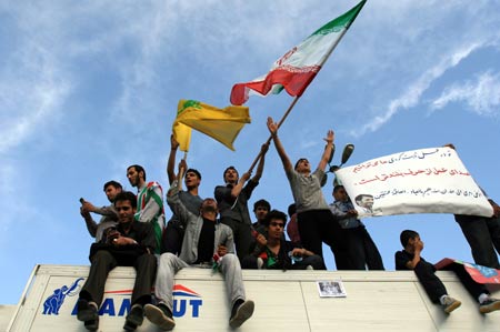 Supporters of Iranian President Mahmoud Ahmadinejad shout and wave flags on top of a truck during a presidental election campaign in Teheran, capital of Iran, June 8, 2009. Tens of thousdands of Mahmoud Ahmadinejad's supporters held a rally here on Monday, supporting the incumbent hardliner Mahmoud Ahmadinejad to grasp the second four-year term in the presidential elections on June 12. [Liang Youchang/Xinhua]