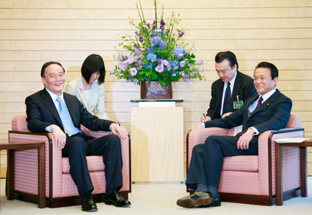 Japanese Prime Minister Taro Aso (1st R) meets with Chinese Vice Premier Wang Qishan (1st L) in Tokyo, Japan, June 8, 2009. During their talks, Wang said that as two major economies in the world, China and Japan are faced with grave challenges posed by the global financial crisis and the worldwide economic recession. [Xinhua] 