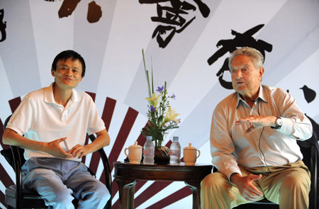 U.S. billionaire George Soros (R) speaks as Ma Yun, chairman of China's-based Alibaba group, looks on during a seminar in Hangzhou, capital of east China's Zhejiang Province, on June 8, 2009. Soros had a discussion with scholars, reporters and local business leaders about world economy here on Monday. [Xinhua]