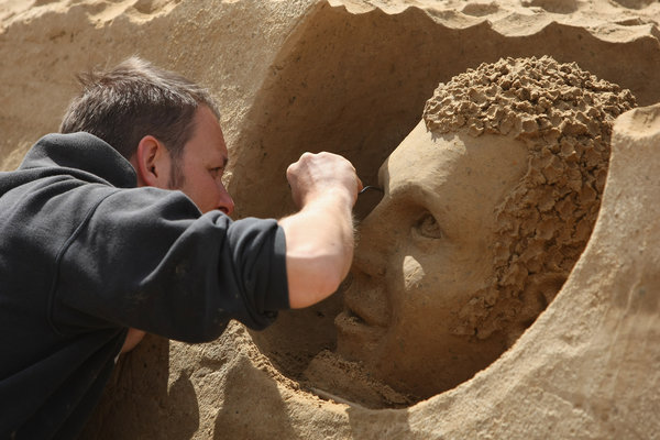 Artist Gianni Schiumarini of Italy works on his sand sculpture at the 7th Sandsation international sand sculpture festival on June 8, 2009 in Berlin, Germany. Sandsation runs through August 30 and has attracted artists from all over the world. [CFP]