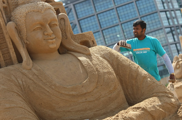 Artist Sudarsan Pattnik of India works on his sand sculpture titled 'Buddha Sitting In Berlin For World Peace' at the 7th Sandsation international sand sculpture festival on June 8, 2009 in Berlin, Germany. Sandsation runs through August 30 and has attracted artists from all over the world. [CFP]