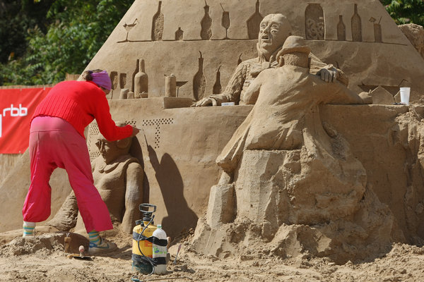 Artist Maria Eliot Torp of Denmark works on her sand sculpture at the 7th Sandsation international sand sculpture festival on June 8, 2009 in Berlin, Germany. Sandsation runs through August 30 and has attracted artists from all over the world. [CFP]