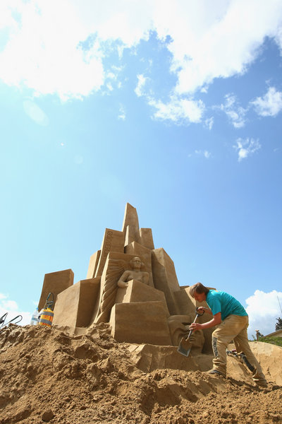 Artist Martin Tulinius of Denmark works on his sand sculpture whose theme is the future of the city of Berlin at the 7th Sandsation international sand sculpture festival on June 8, 2009 in Berlin, Germany. Sandsation runs through August 30 and has attracted artists from all over the world. [CFP]