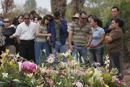 People held a funeral for children who died in a fire in a daycare center in Hermosillo, Sonora state, Mexico, on June 8, 2009. The fire took place in the daycare center here on June 5 have already claimed 43 children's lives.[Xinhua] 