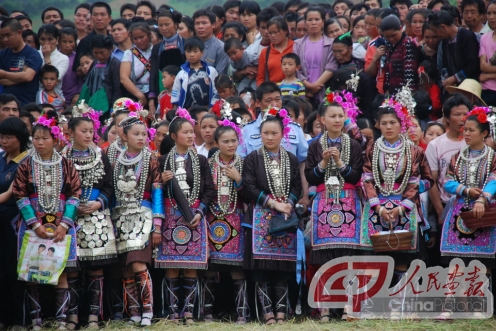 Dong women garbed in elegant dress at a festival.