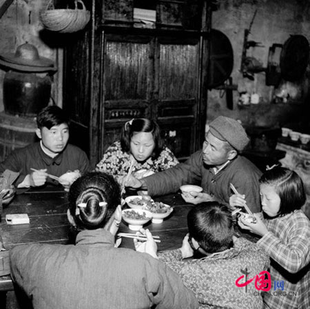 28 year old Zhou Meisheng has dinner with his family. 1957