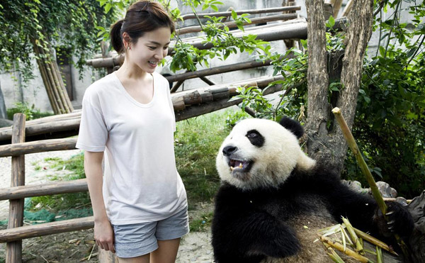 South Korean actress Song Hye-Kyo plays with giant pandas during her visit to a panda breeding center in Chengdu, southwestern China's Sichuan Province. She has been named 'Asia's panda ambassador'. She says she is looking forward to adopting a panda in the near future. 