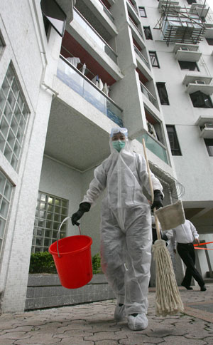 An epidemic prevention worker disinfects the place where the first second-generation A/H1N1 flu case in Hong Kong lived, in Hong Kong, south China, June 10, 2009. Controller of the Center for Health Protection of Hong Kong Thomas Tsang said at a press briefing Wednesday that a 55-year-old man who did not have overseas travel record recently was confirmed to have contracted A/H1N1 flu. 