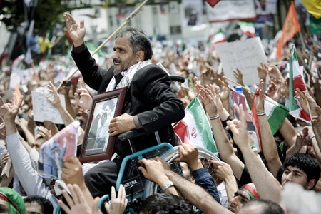 Supporters of Iranian President Mahmoud Ahmadinejad attend his last presidential campaign in Tehran, capital of Iran, on June, 10, 2009, prior to the upcoming 10th presidential election slated for Friday. Four candidates of the election -- incumbent President Mahmoud Ahmadinejad, former Prime Minister Mir Hossein Mousavi, former Parliament Speaker Mehdi Karroubi and former Revolutionary Guards chief Mohsen Rezaei -- are racing for the presidency.[Zhang Ning/Xinhua]