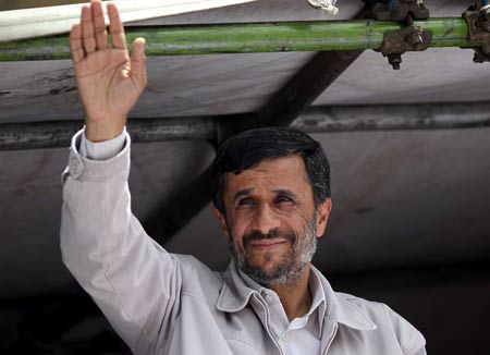 Iranian President and candidate for the upcoming presidential election Mahmoud Ahmadinejad waves to supporters before addressing them in front of the Sharif University in Tehran June 10, 2009.