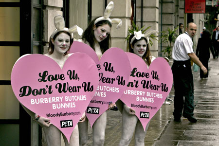 Three female members of PETA Europe protest against Burberry's use of fur outside the company's annual shareholder meeting at Bafta in London July 12, 2007. The members posed naked with heart-shaped signs reading 'Love Us, Don't Wear Us' and 'Boycott Burberry.' [CFP]