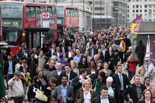 Commuters on London Bridge try to make their way home during the 48 hour tube strike that started in London this morning.[CFP