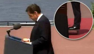 French President Nicolas Sarkozy stands on a small platform while speaking during the 65th anniversary of D-Day at the Normandy American Cemetery and Memorial in Colleville-sur-Mer, France June 6, 2009.[Photo:CCTV.com]