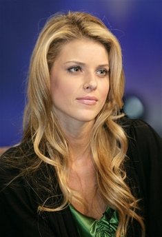 In this April 26, 2009 file photo, Miss California USA Carrie Prejean listens to a question at the Rock Church during services in San Diego.