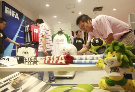 Chinese customers select commodity items inside the first souvenir shop officially authorized by FIFA in China for the 2010 FIFA World Cup South Africa, at a downtown shopping mall in Shanghai, China, June 11, 2009.[Xinhua]