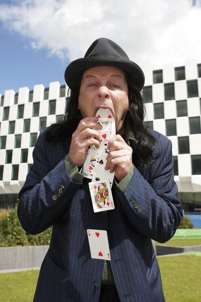 Magician Nick Nicolas vomits up a deck of cards as part of his act at the launch of the AIB street performance championships at Grand canal dock in Dublin, Ireland.[CFP]