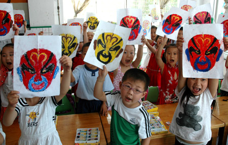 Chinese kids show off their drawings of Peking Opera facial make-ups at a kindergarten in Jiyuan City of central China's Henan Province, June 12, 2009, during a campaign marking the fourth Cultural Heritage Day of China, which falls on June 13 this year.