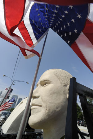 An eight-foot-tall sculpture of the head of U.S. President Barack Obama is displayed in the Grant Park area of downtown Chicago, Illinois June 13, 2009. The 20-foot-tall bust, which includes the top part of a suit and a pin of the American flag, is created by sculptor David Adickes and will be placed with 42 other sculptures of previous presidents made by Adickes at the President's Park in South Dakota. [Xinhua/Reuters]