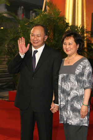 Film director John Woo and his wife attend the opening ceremony of the 12th Shanghai International Film Festival in Shanghai, east China, June 13, 2009. [Zhu Liangchengn/Xinhua]