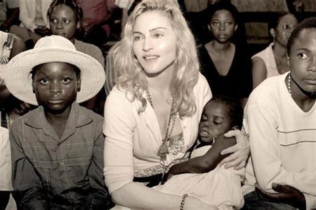 Pop star Madonna holds the child named Mercy in this undated publicity photo taken in Malawi and released to Reuters April 13, 2009.