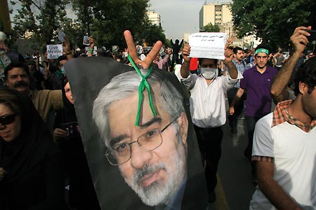 Supporters of Iran's former Prime Minister Mousavi hold a picture of Mousavi during a rally in Tehran, capital of Iran, June 15, 2009. Tens of thousands of people were seen on Monday at Tehran's Enghelab Avenue marching all the way west to the prestigious Azadi (liberty) square, for a massive rally to support the defeated presidential candidate Mir- Hossein Mousavi. [Xinhua]