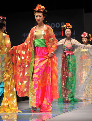 Model present creations inspired from the court dress in ancient China's Tang Dynasty (618-907), during a show of the 2009 Qingdao Fashion Week in Qingdao, a coastal city in east China's Shandong Province, June 15, 2009.[Li Ziheng/Xinhua]