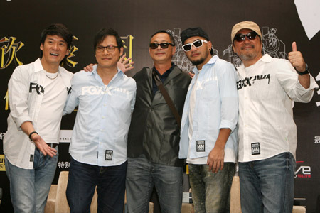 A tetrad of Chinese well-known singers Chow Wah Kin, Dai Yau Law, Chang Chen-yue, and Jonathan Lee pose for a group photo with the special guest Johnnie To (C), a noted Hong Kong movie director, during a press meeting for their Super Band Concert scheduled on July 11 at the Hongkou Stadium, in Shanghai, east China, June 15, 2009.[Zhu Liangcheng/Xinhua]