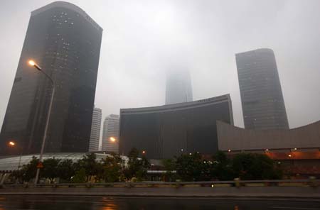 The street lamps are turned on along eastern Chang'an street in Beijing, China, June 16, 2009. Local authority released a yellow alert for lightings on Tuesday. [Gao Xueyu/Xinhua]