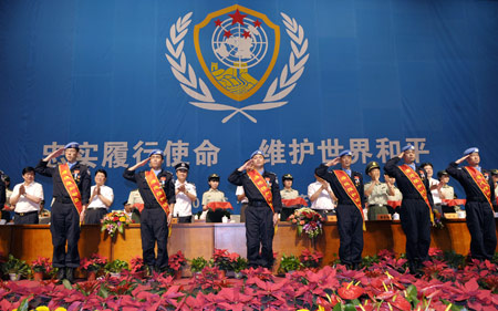 Members of the seventh squad of Chinese peacekeeping riot police in Haiti salute after being awarded in Urumqi, capital of Xinjiang Uygur Autonomous Region, northwestern China, June 16, 2009. (Xinhua/Zhao Ge)