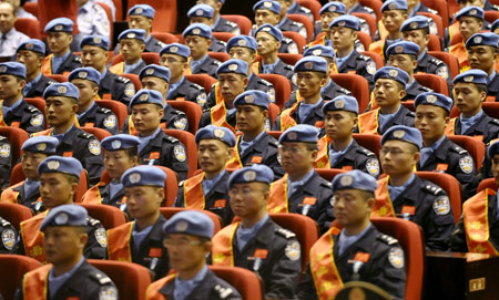 Members of the seventh squad of Chinese peacekeeping riot police in Haiti attend the awarding ceremony in Urumqi, capital of Xinjiang Uygur Autonomous Region, northwestern China, June 16, 2009. (Xinhua/Zhao Ge)