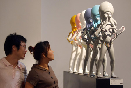 Visitors view a sculpture named 'Octopus Man. Man Octopus' at an exhibition for graduates of China Academy of Art in Hangzhou, capital of southeast China's Zhejiang Province, June 16, 2009. More than 100 sculptures and art installations designed by 66 students were exhibited here. [Xinhua]