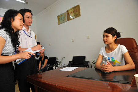 Deng Yujiao (1st R) receives an interview after the trail at a local court in Badong County, central China's Hubei Province, June 16, 2009. 