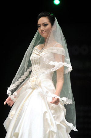 A model displays a wedding dress during the 2009 China Qingdao international fashion week in Qingdao, eastern China's Shandong Province, June 15, 2009. 