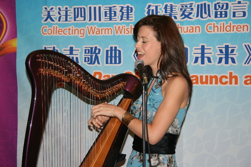 Katie performs her song, Day by Day, to the accompaniment of her Celtic harp. 