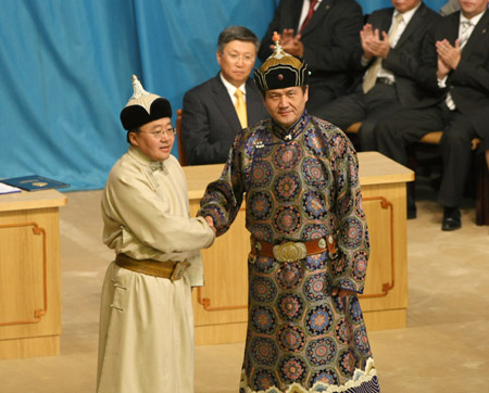 Mongolian President-elect Tsakhia Elbegdorj (L) shakes hands with the outgoing President Nambaryn Enkhbayar during the inauguration ceremony in Ulan Bator, capital of Mongolia, on June 18, 2009. [Hao Lifeng/Xinhua]