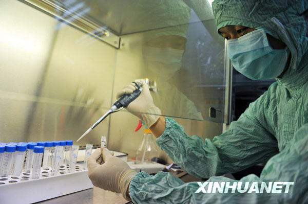 A researcher dilutes the virus strains of the influenza A/H1NI for cuvette cultivation of its vaccination at a lab of the Wuhan Institute of Biological Products in Wuhan, central China's Hubei Province, June 17, 2009. A total of 6 virus strains of the influenza A/H1NI supplied by the World Health Organization (WHO) were delivered here and started for their proliferated cultivation in the morning. [Zhou Chao/Xinhua]