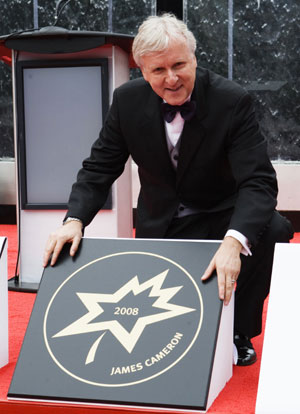 Canadian director James Cameron poses with his star during Canada's Walk of Fame induction ceremonies in Toronto September 6, 2008.