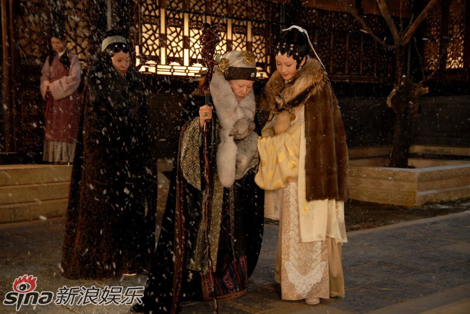 Wang Xifeng, the actual family manager, with Baoyu's grandmother Mrs. Jia