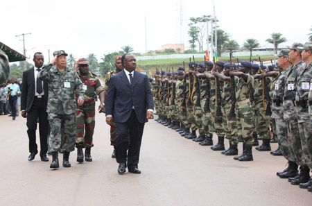 Gabonese Defense Minister Ali Bongo (R front) and head of Chinese delegation lieutenant general Wang Qian (L front) inspect soldiers during the opening ceremony of 