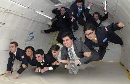 Bride Erin Finnegan (3rd R) and bridegroom Noah Fulmor (3rd L), both of New York, are helped by the rest of the wedding party as they float after performing the first weightless wedding aboard a specially-equipped Boeing 727, owned by Zero Gravity Corporation, while flying over the Gulf of Mexico after taking off from Titusville, Florida, June 20, 2009.